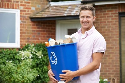 Man holding full recycling bin