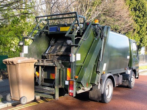 Garbage truck collecting trash