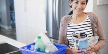 Woman sorting her recycling bin