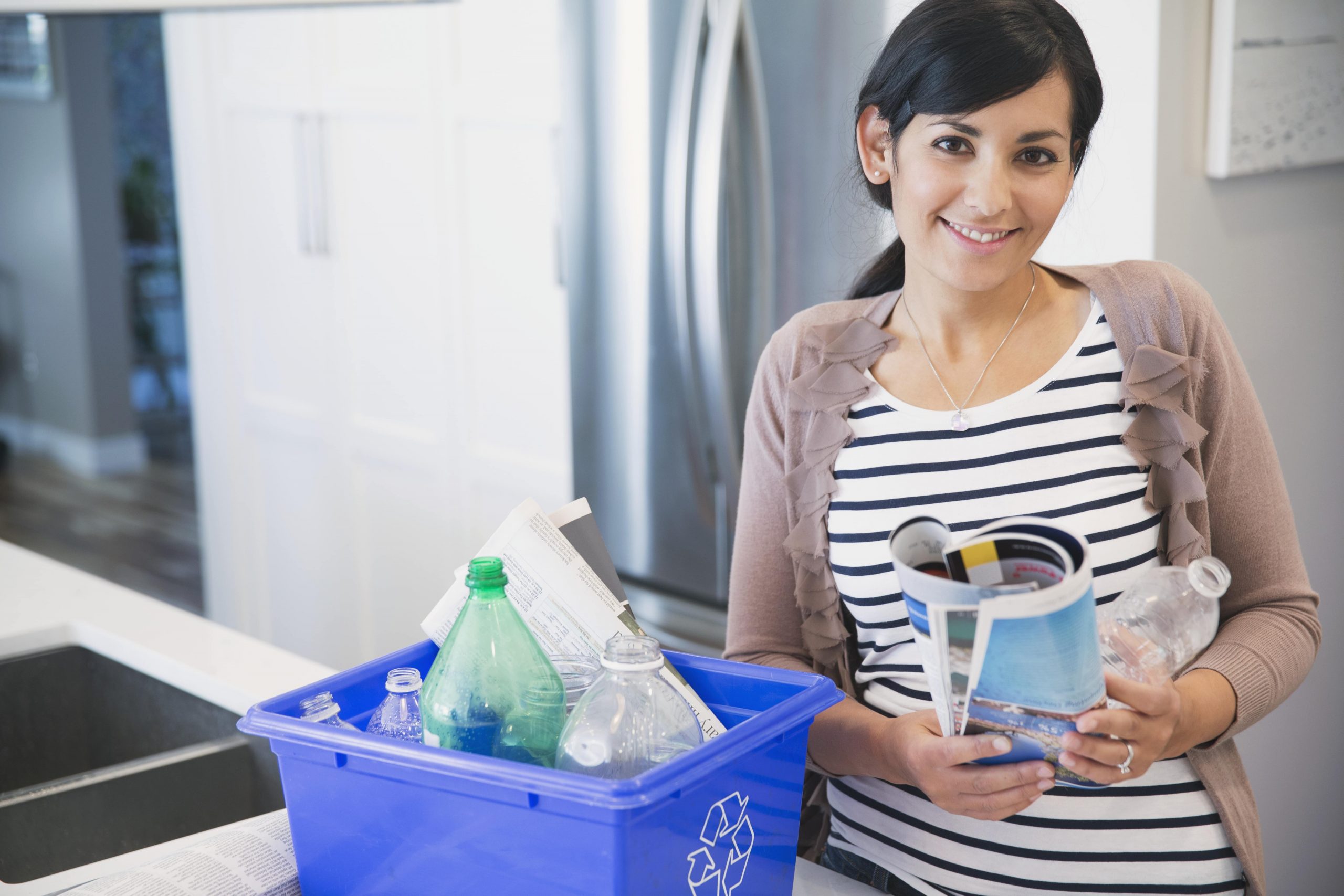 Woman sorting her recycling bin