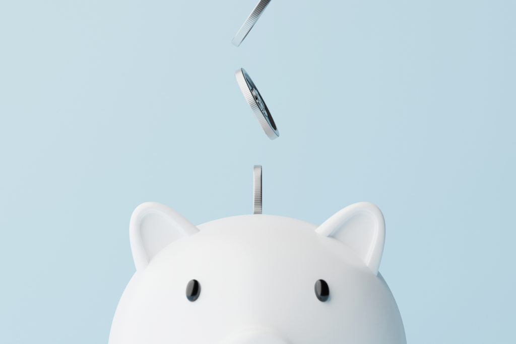 Save money and investment concept. Closeup piggy bank and silver coins falling. 3d rendering illustration