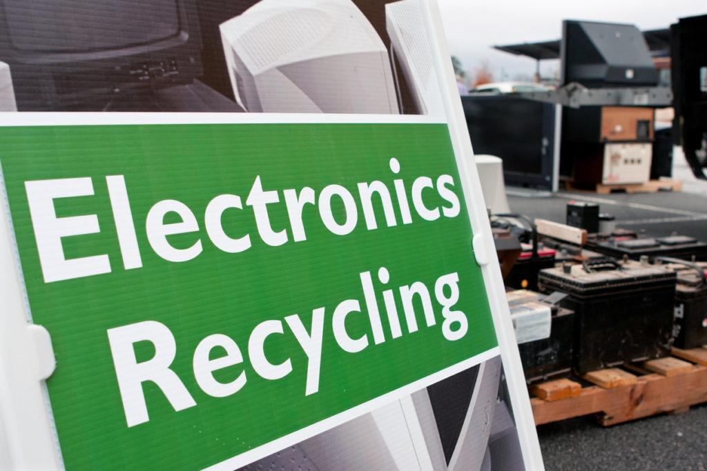 An "Electronics Recycling" sign marks the spot for people to drop off old computers, TV's, etc. 