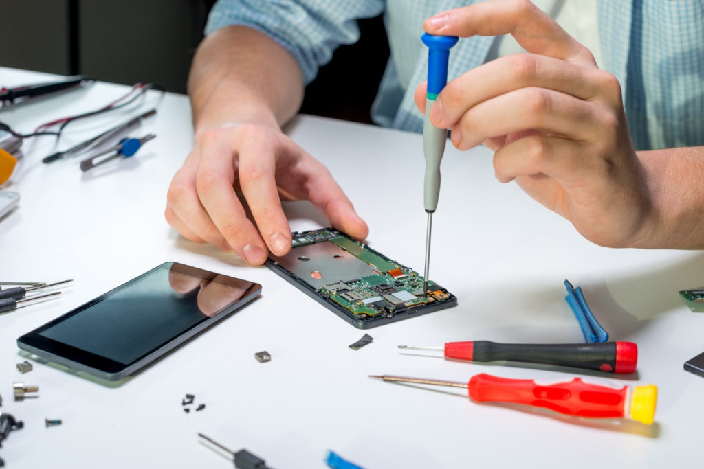 Person repairs mobile phone