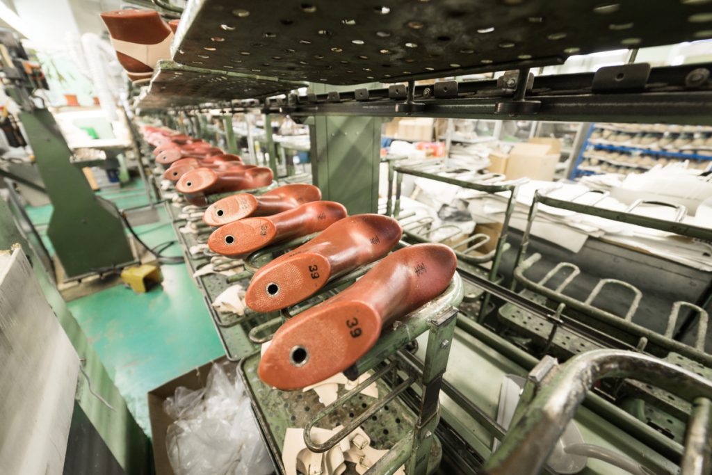 The conveyor with shoe lasts. Shoe factory, mass production of footwear.