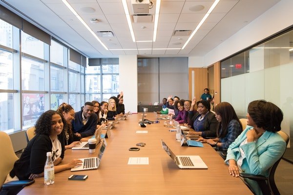 Government employees at a conference table preparing for a meeting