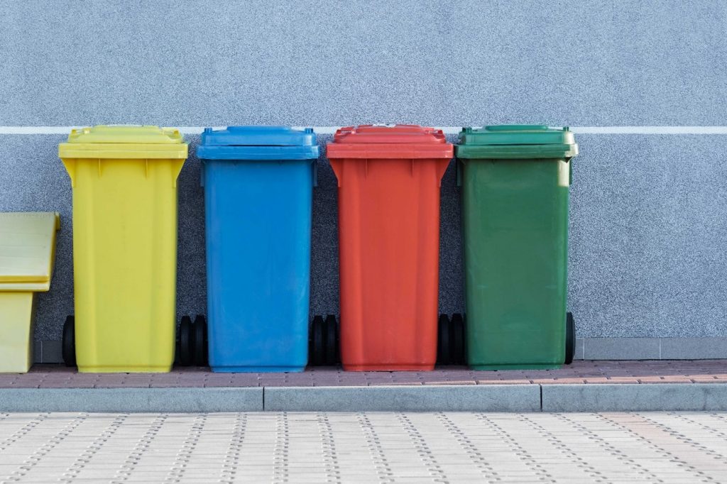 Different color waste containers in a row