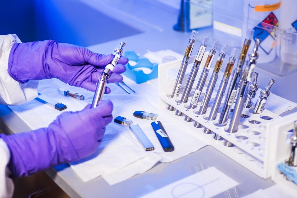 Laboratory technician working with vape pens containing lithium-ion batteries