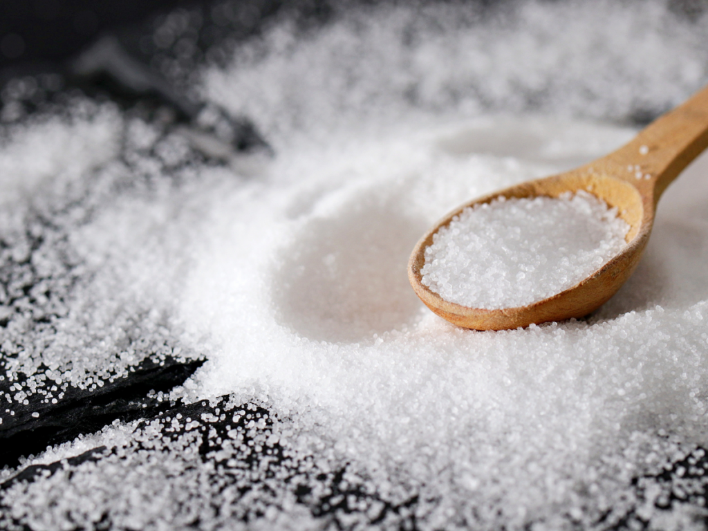 table salt with a wooden spoon