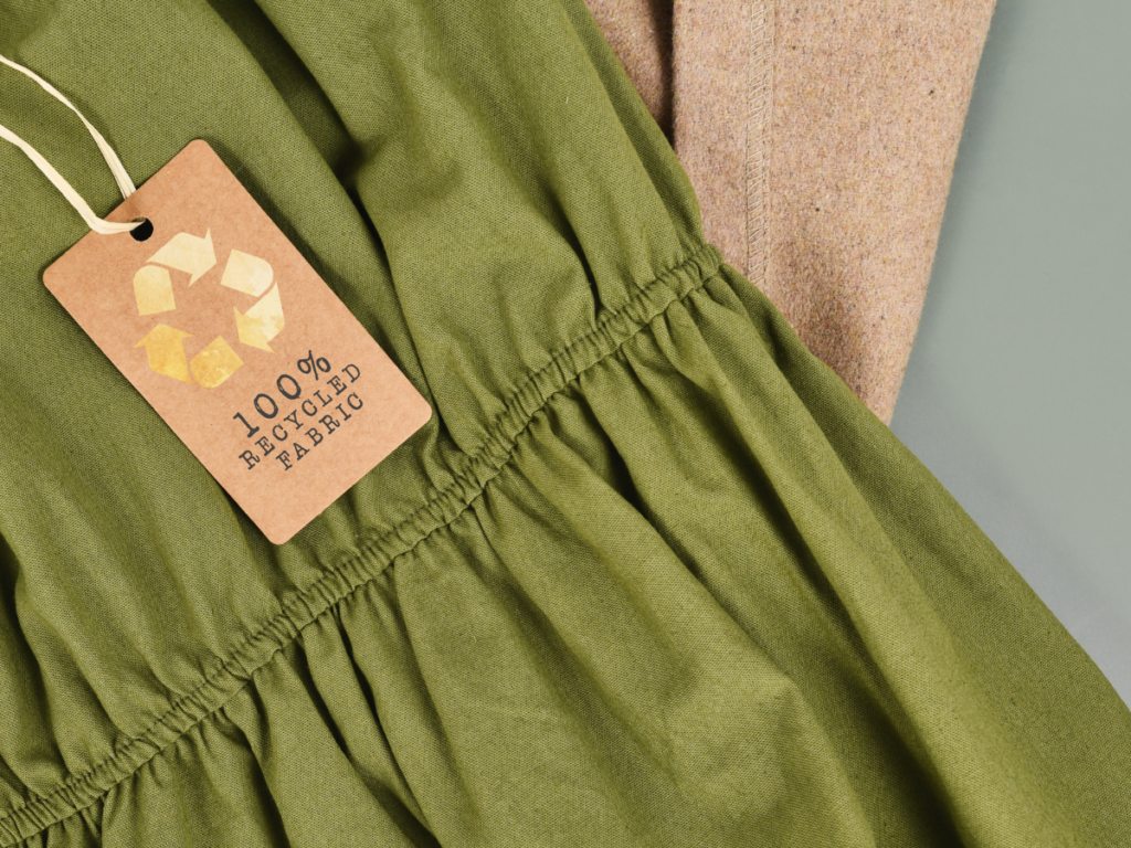 a green dress with a tag that says 100% recycled fabric