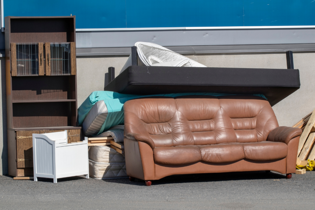 a pile of furniture on the curb ready for junk removal pick up