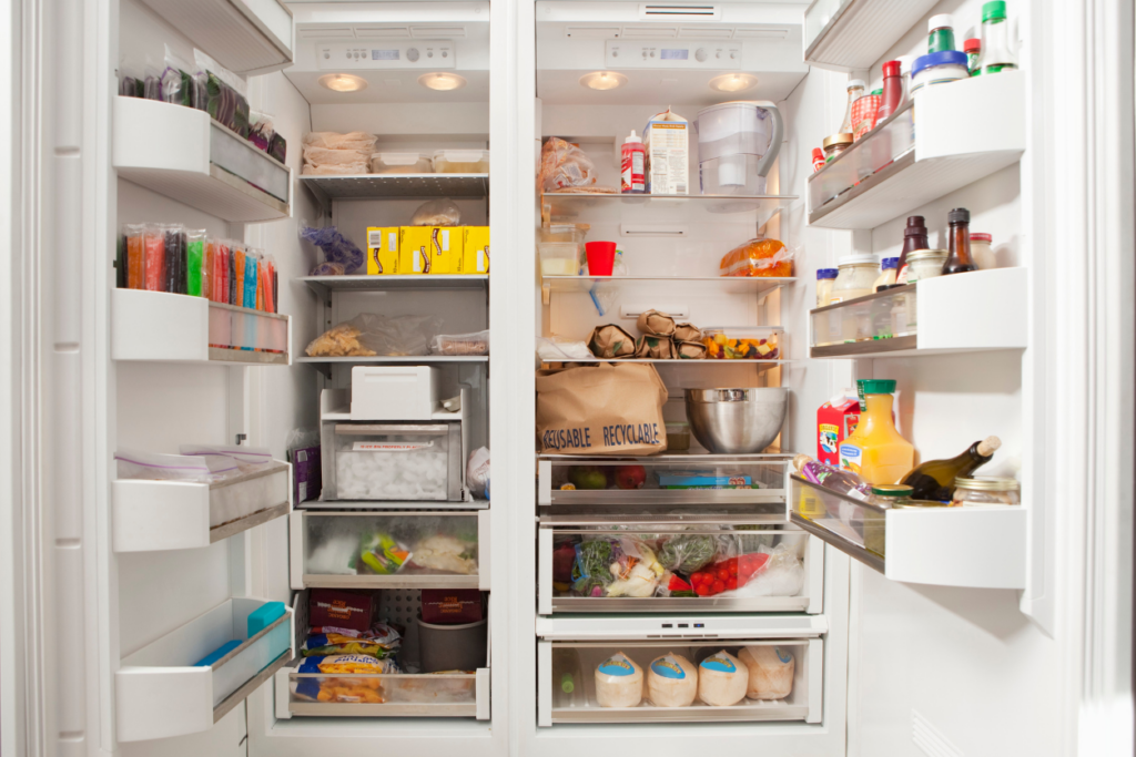 open refrigerator and freezer filled with food 