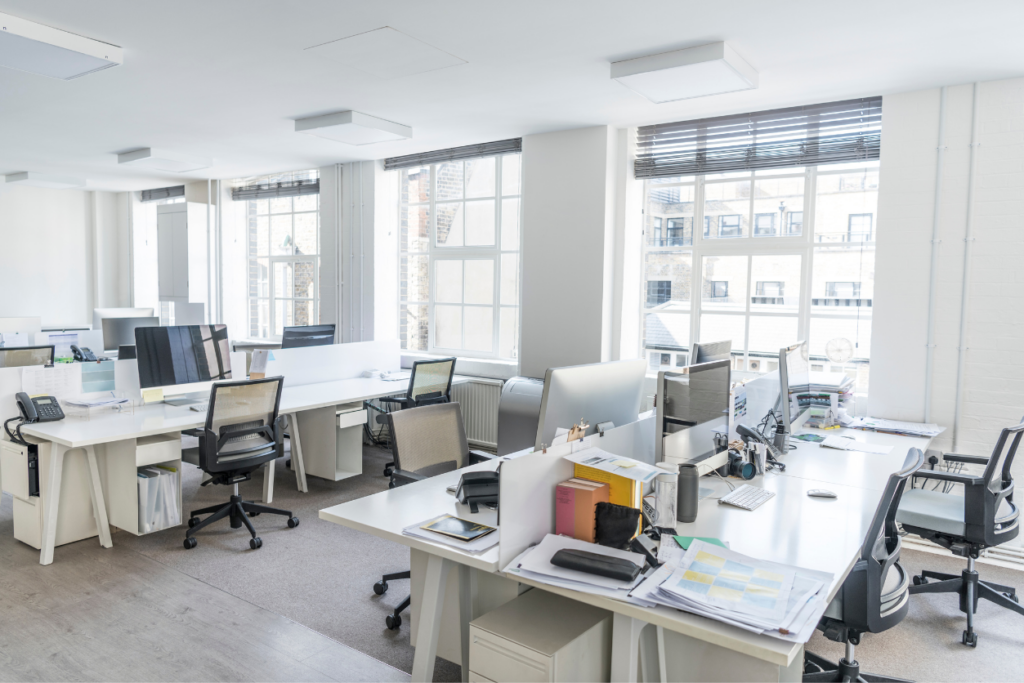 office with many desks leaving the lights off and using natural light instead