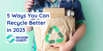 Person holding paper bag filled with recyclable items