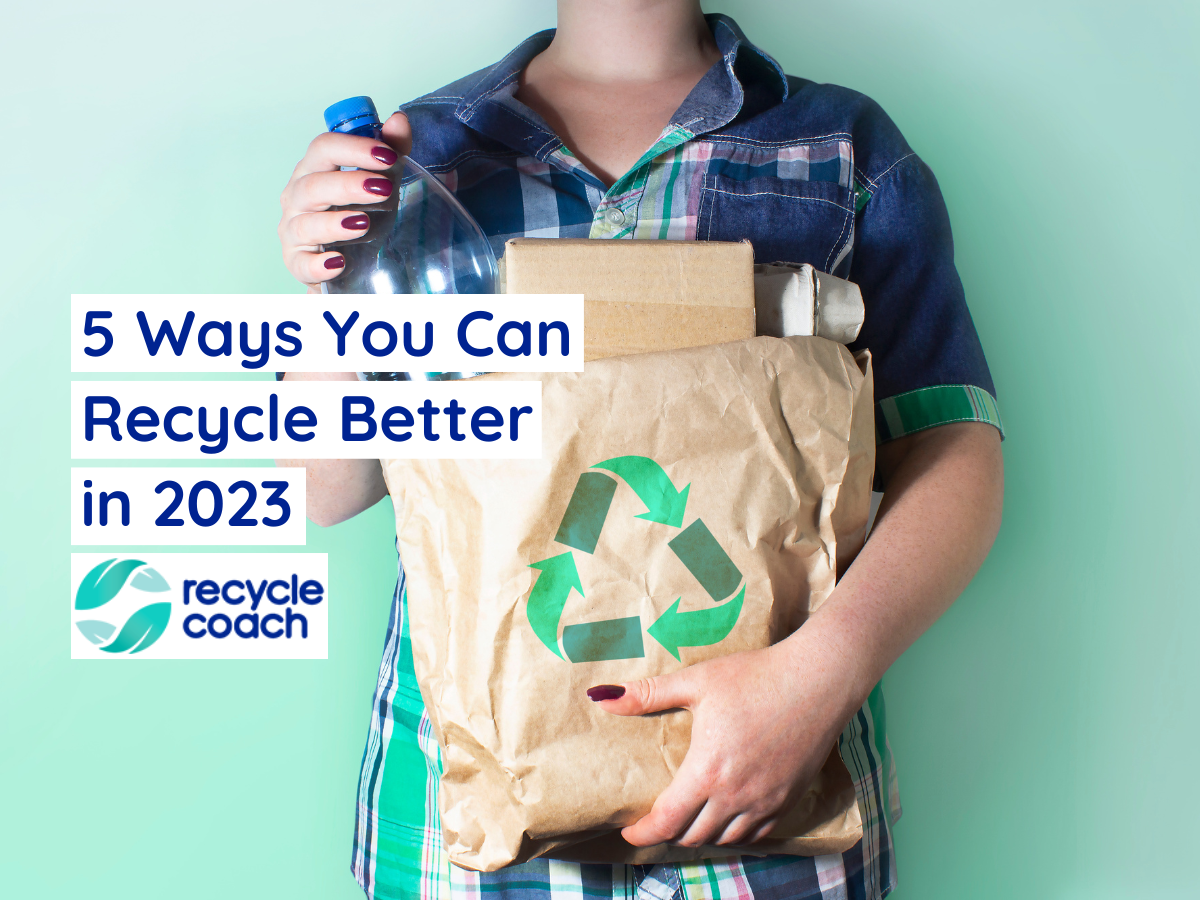 Person holding paper bag filled with recyclable items