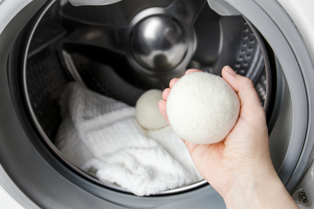 hand holding a wool dryer ball before placing it in the dryer